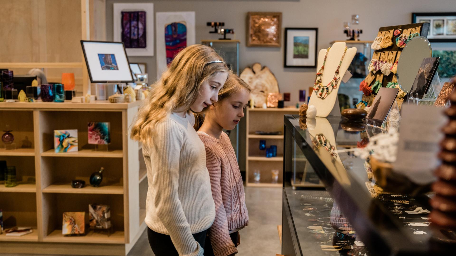 Two girls touring Two Rivers Gallery's gift shop
