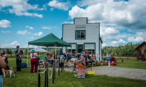 People line up to ride the Central BC Railway and Forestry Museum's Cottonwood Minirail outside of Huble Homestead