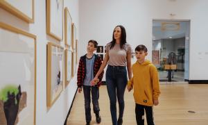 A young family tours Two Rivers Gallery