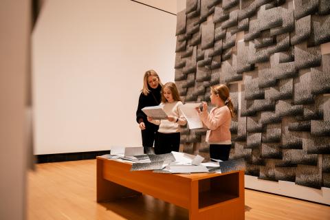 A family inspects art at Two Rivers Gallery 