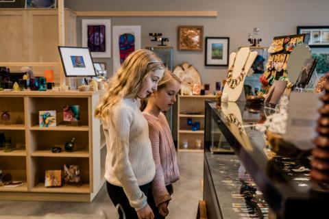 Two girls touring Two Rivers Gallery's gift shop